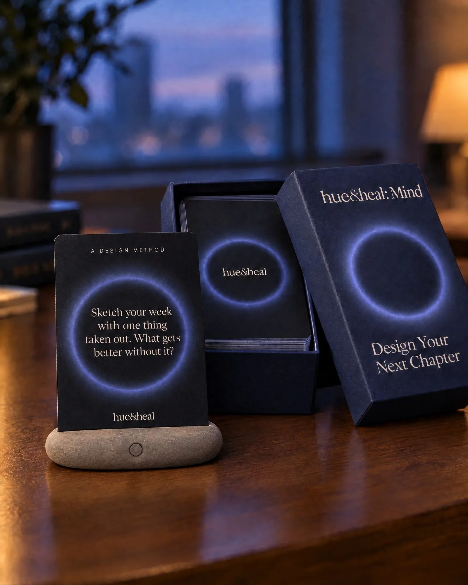 A card on a pebble stand at dusk, the box open behind it.